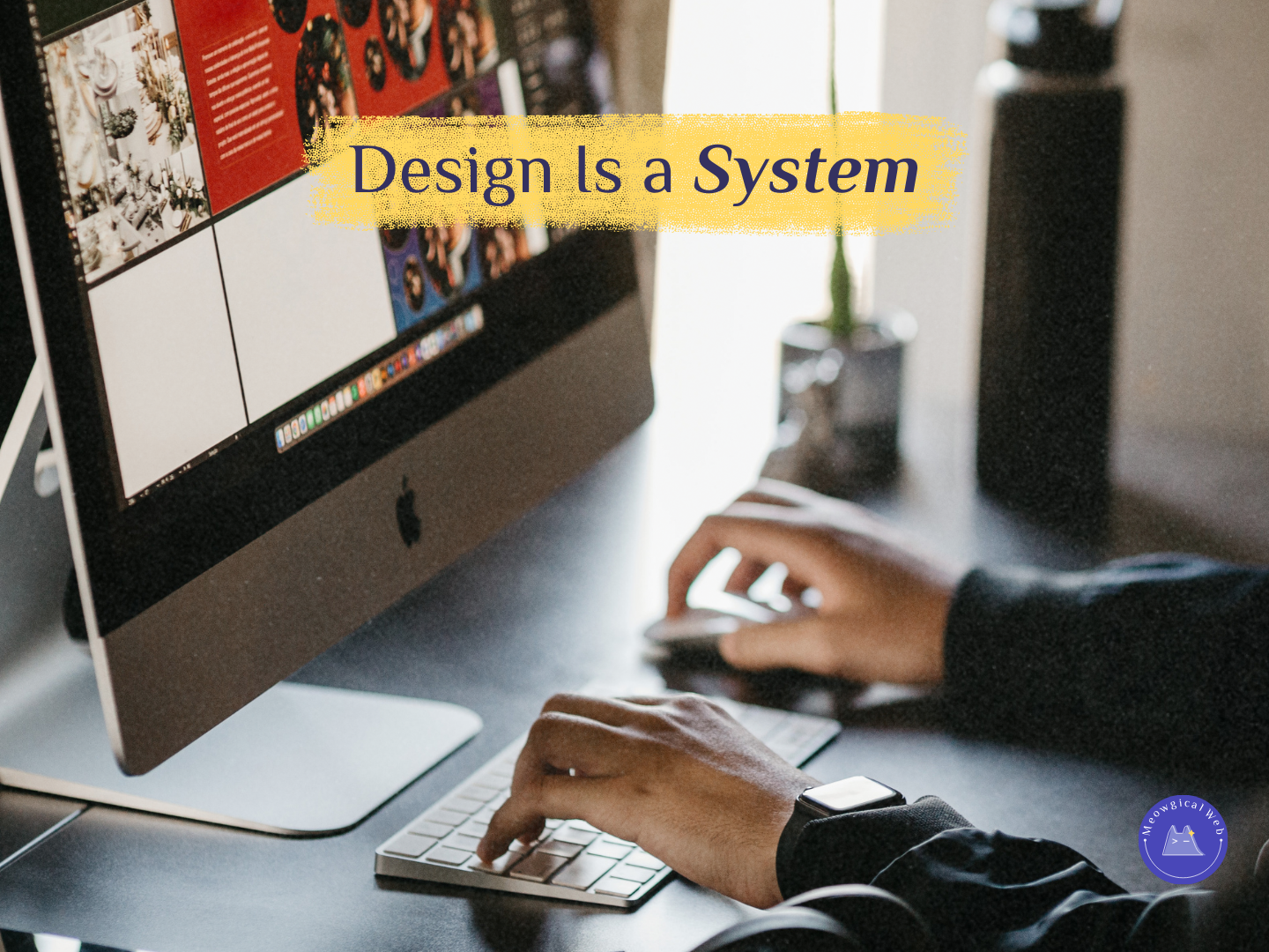A person working at a desk using a desktop computer and keyboard while reviewing a website layout on screen, illustrating system based web design and user journey thinking for pet businesses